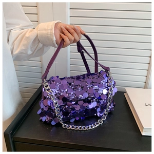 Detail of purple sequin handbag with large circular flakes and chunky silver chain strap