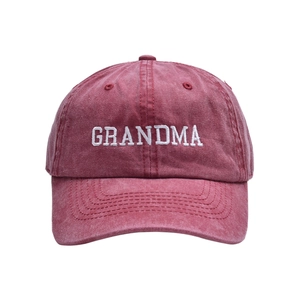 Detail view of GRANDMA white embroidery on vintage washed red cotton baseball cap