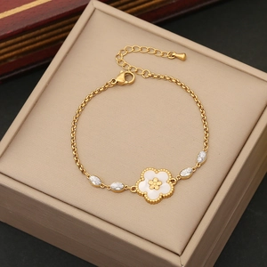 Gold stainless steel flower bracelet with white enamel petals and marquise gemstones