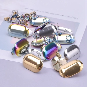 Close-up of polished 304 stainless steel geometric capsule earrings in gold, silver and rainbow