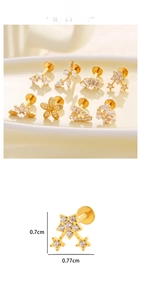Detail view of F136 titanium gold labret studs with zircon stars and flowers shapes