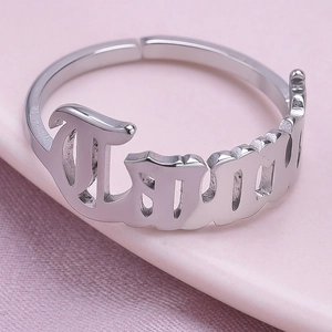 Detailed close-up of adjustable stainless steel ring with Gothic 'Family' cut-out design