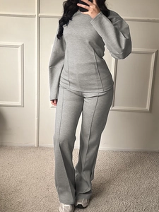 Detail view of grey long sleeve sweatshirt and pants set with unique side stitching