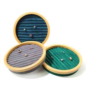 Round bamboo jewelry display tray with velvet slots for ring and earring storage