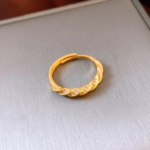 Détail macro d'une bague en plaqué or 24 carats avec texture bambou et zircons blancs