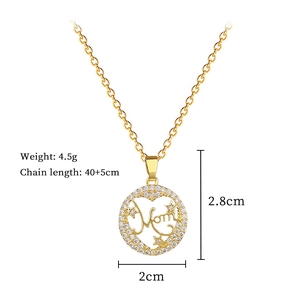 Detail of gold Mom heart pendant with star elements and pave-set white zircon stones