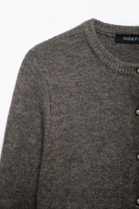 Detailansicht der dunkelbraunen Strickpullover-Textur mit Kragen und Knopfelementen