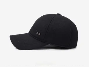 Detail view of the thick wool texture and metallic fashion plaque on the winter baseball cap