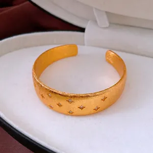 Elegant 18k gold plated star open bangle featuring brushed metal and inset crystals