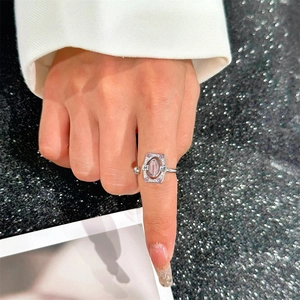 Close-up of vintage geometric silver ring with oval pink stone and crystal accents