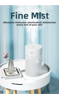 Detail of white minimalist USB humidifier on wood table with cool mist spray effect