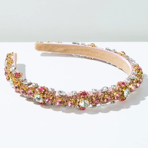 Close-up of pink baroque headband with hand-set sparkling crystals and golden rhinestones