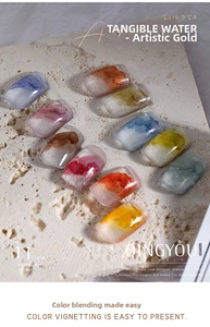 Artistic nail art display featuring 11 watercolor marble effect tips on stone base