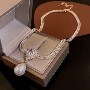 Luxurious pearl and zircon teardrop necklace with heart detail on a premium display