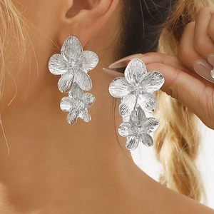 Elegant silver flower drop earrings with brushed metallic texture in minimalist style