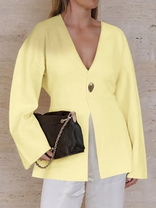Detail view of yellow long sleeve V-neck cardigan with a single decorative front button
