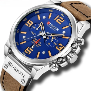 Close-up of Curren mens watch showing chronograph dial and brown leather strap detail