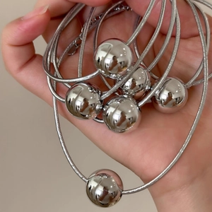 Minimalist silver shiny sphere necklace with polished metallic balls on snake chain
