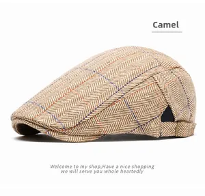 Detail of camel herringbone plaid beret featuring an adjustable metal buckle