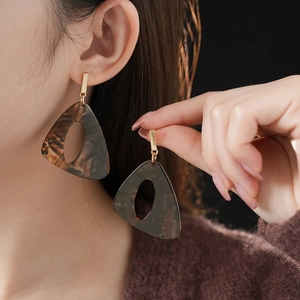 Modern resin leopard print earrings with irregular triangle shape and gold metal accents