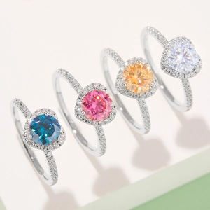 Macro shot of 1ct heart moissanite rings in blue, pink, and yellow colorful settings