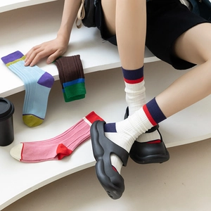 Detail of colorful striped cotton crew socks with ribbed texture and mixed color block design