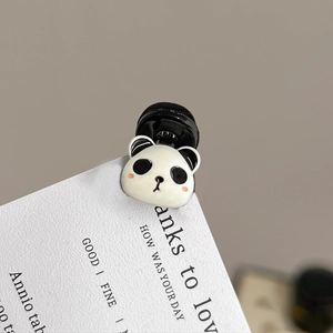Close-up of a cute black and white panda head hair claw clip with a secure metal pin back