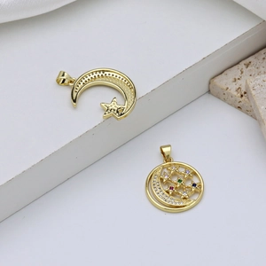 Gold plated moon and star pendants with colorful cubic zirconia on minimalist background