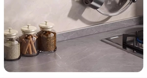 Detail of grey marble kitchen sticker applied to stovetop and backsplash surface