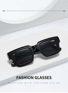 Detail of square black sunglasses with thick frames on a minimalist white display