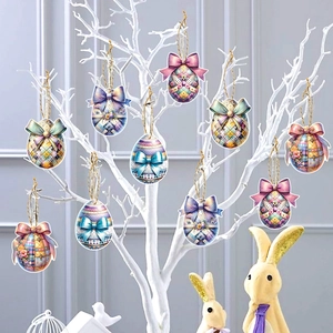 Easter egg hanging tags with bows and gold strings on white branches for festive party decor