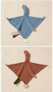 Detailed texture of cotton muslin baby swan security blankets in blue and brown