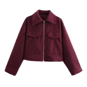 Detail of burgundy wool-like jacket featuring silver zipper and large flap pockets