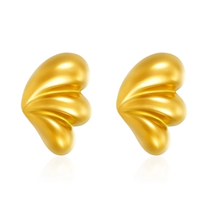 Macro detail of gold plated stainless steel triple drop earrings with mirror finish