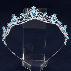 Elegant silver bridal crown with blue gemstones and crystals on a professional display