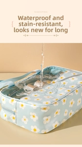 Waterproof testing of the daisy print makeup bag showing its durable water resistance