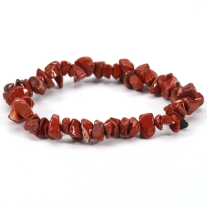 Macro view of red jasper natural stone chip bracelet with elastic cord texture