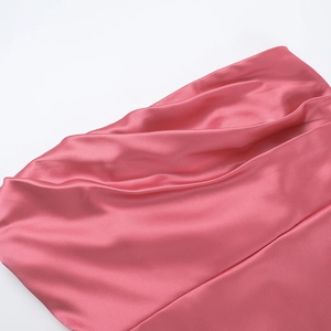 Detailed view of pink satin fabric showing elegant drapes and smooth reflective texture