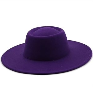 Detailed close-up showing the smooth wool felt texture of a deep purple wide brim fedora hat