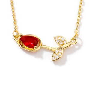 Elegant gold tulip necklace with red crystal pendant and micro-set cubic zirconia accents