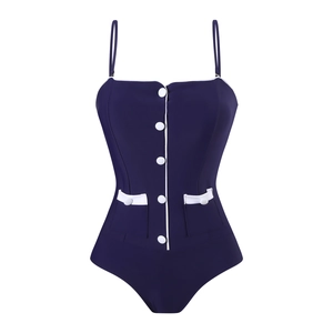 Detail of navy one-piece swimsuit with white piping, decorative buttons and faux pockets