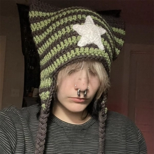 Detail of hand-knit cat ear beanie featuring olive stripes and braided tassels