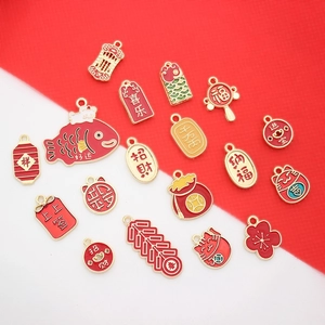 Close-up of red and gold metal DIY flower pendants with Chinese luck characters