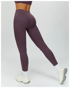 Detail view of purple high-waisted yoga leggings with ergonomic seams for butt-lifting