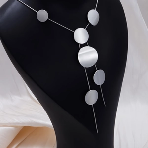 Detailed view of silver minimalist long necklace with hollow round geometric discs