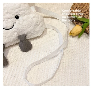 Close-up of fluffy cloud plush bag showing soft faux lamb wool and cute embroidered face