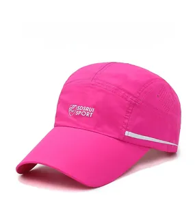 Detail view of breathable mesh fabric and reflective strip on pink quick-dry sports cap