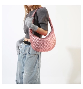 Detail of pink metallic quilted half-moon shoulder bag with cloud-like texture