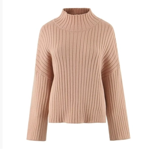 Detail of mauve high-neck knit sweater featuring thick ribbed texture and premium fabric