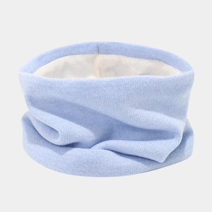 Detail of light blue knit neck warmer with soft white fleece lining for winter warmth